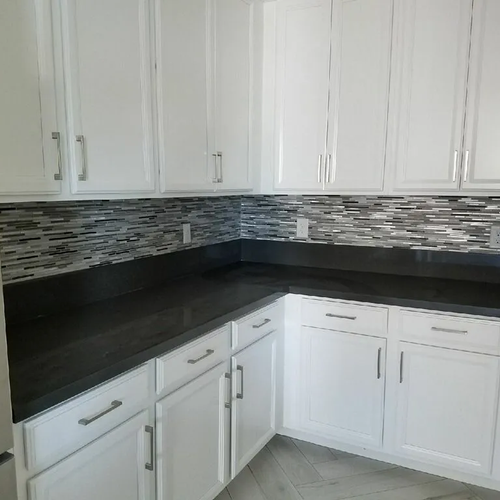 Compact kitchen with dark tile backsplash